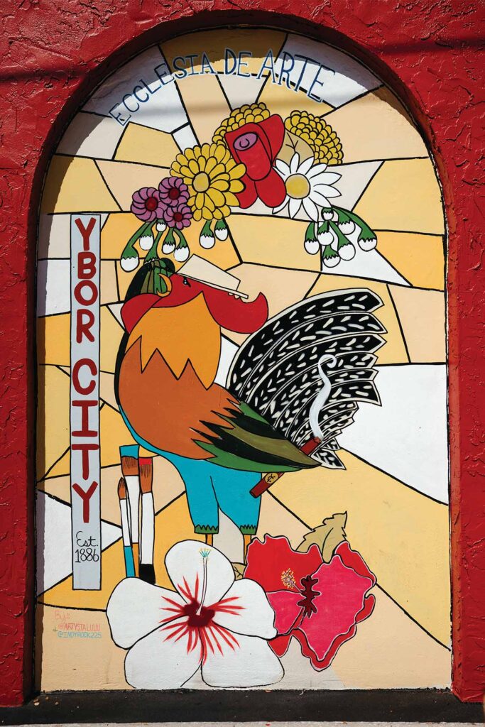 a stained glass window with a rooster and flowers