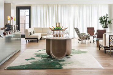 a room with a table of wine glasses and a couch