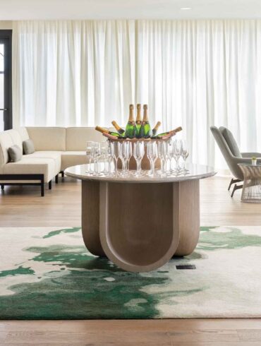 a room with a table of wine glasses and a couch