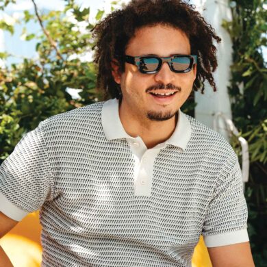 a person wearing sunglasses and a white shirt