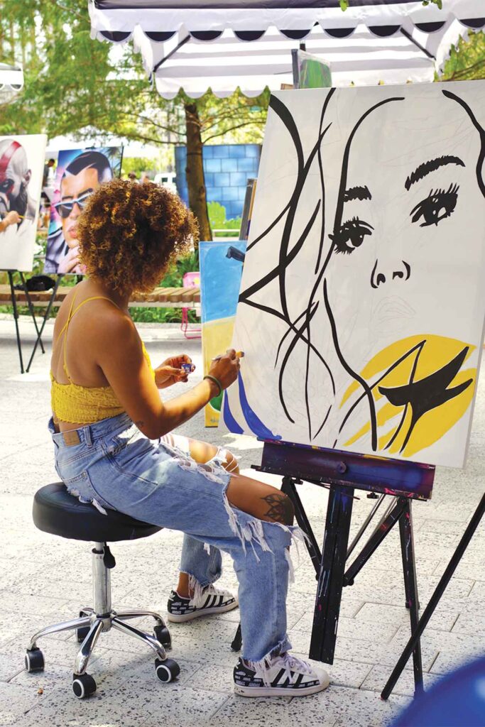 a person painting on canvas