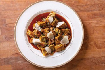 a plate of pasta with sauce and cheese