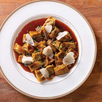 a plate of pasta with sauce and cheese